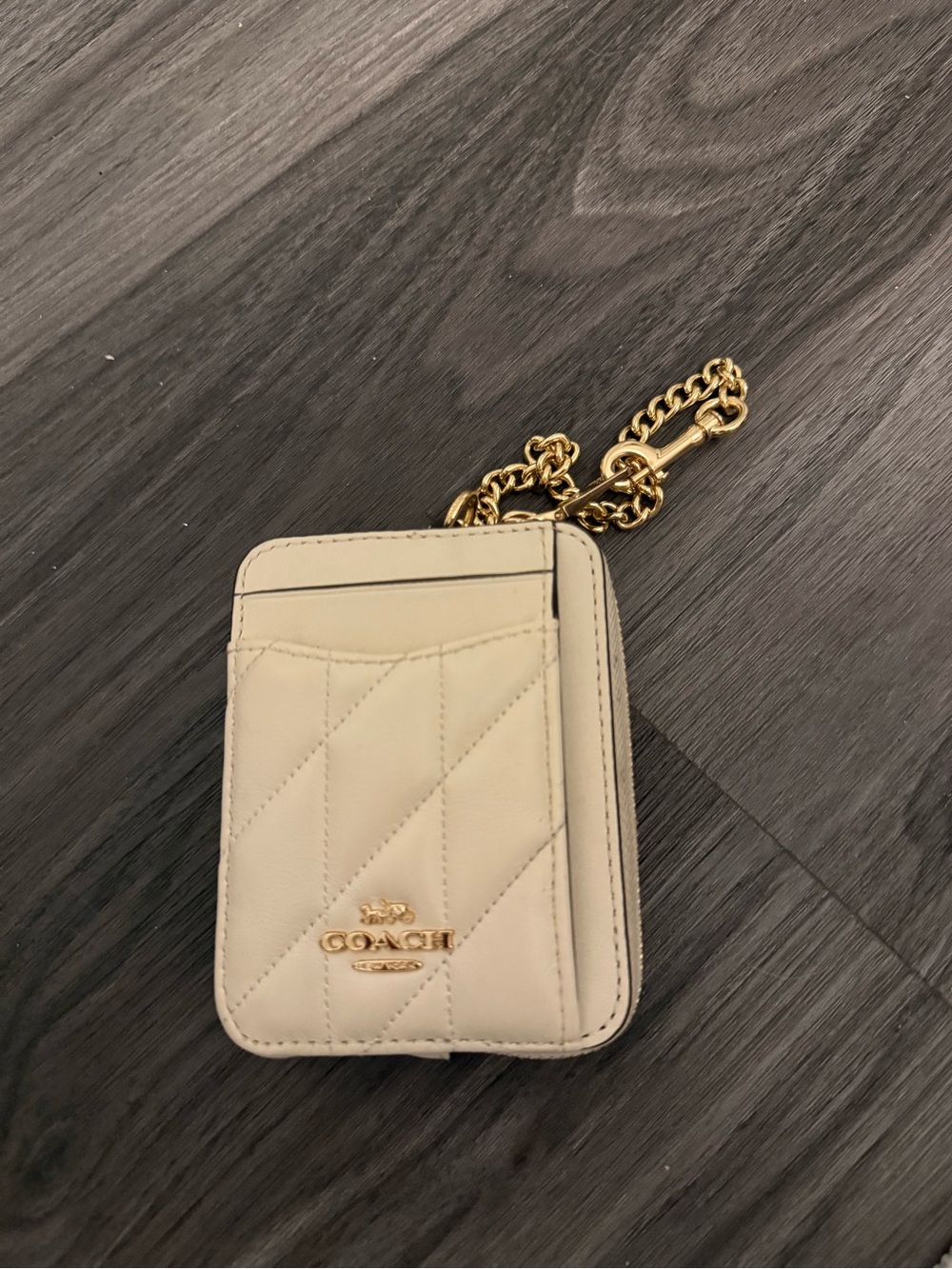 Coach Cream Quilted Card Holder with Gold Chain very tiny dirt mark near zipper.